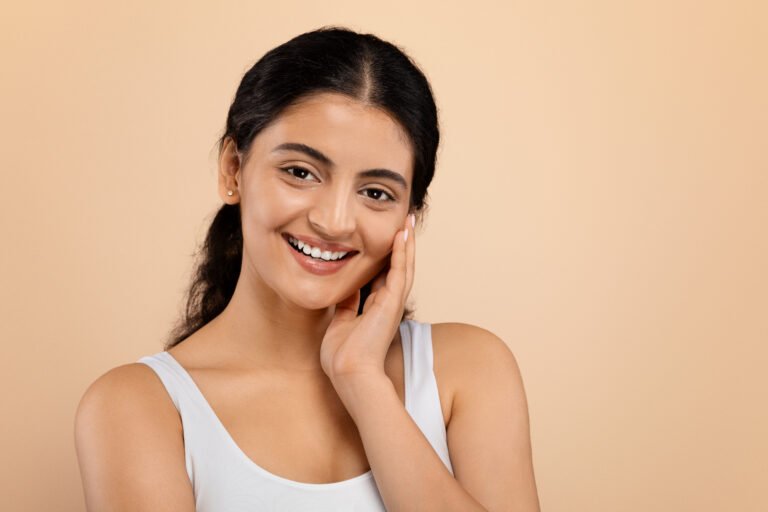 Shy Beautiful Indian Woman Touching Her Smooth Skin And Looking At Camera