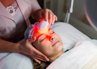 Skin Care. Young Woman Receiving Facial Beauty Treatment, Removing Pigmentation At Cosmetic Clinic. Intense Pulsed Light Therapy. IPL. Rejuvenation, Photo Facial Therapy. Anti-aging Procedures.