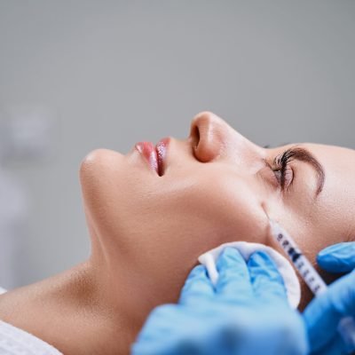 Young girl is visiting cosmetologist and getting beauty injections for rejuvenation face and lifting skin